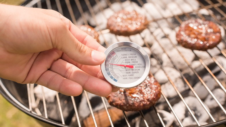 Meat thermometer next to a grill