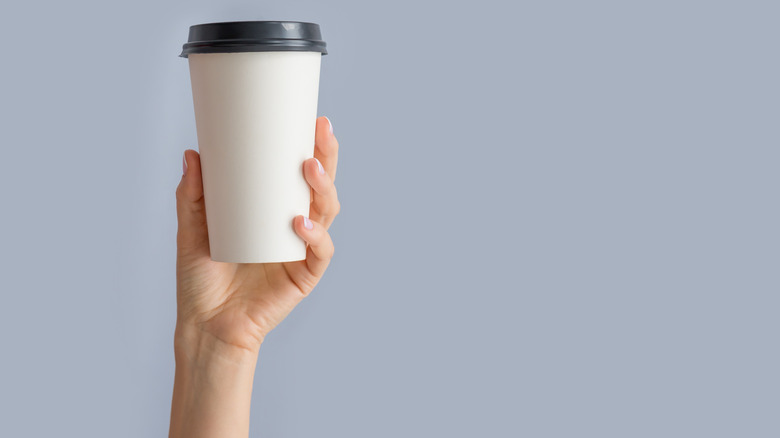 person holding coffee cup