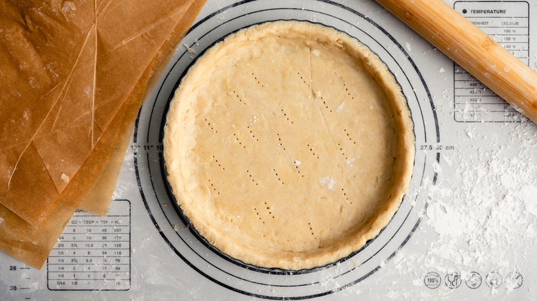 Pie on mat with rolling pin