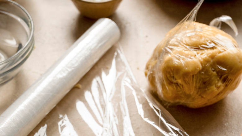 Raw dough in clear cling wrap