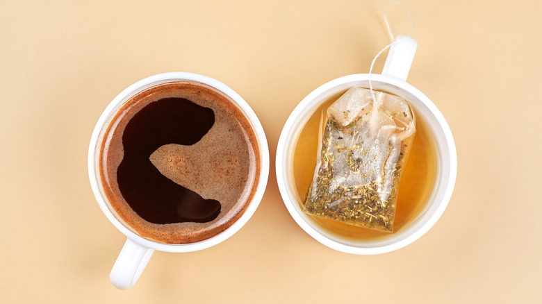 overhead shot of two mugs of tea and coffee side by side