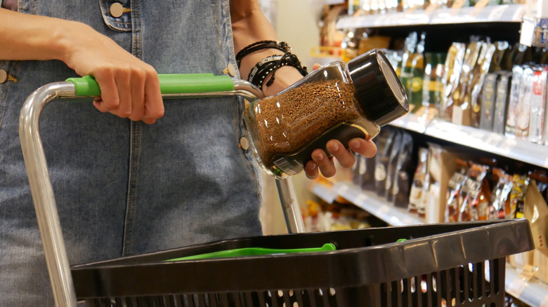 Someone buying instant coffee in a grocery store