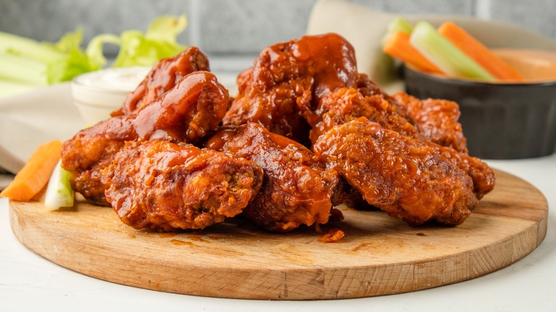 Buffalo wings on wooden board 