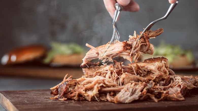 Pulled pork on wooden board 