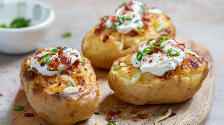 Loaded potatoes on wooden board 