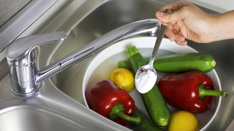 Person washing vegetables with baking soda