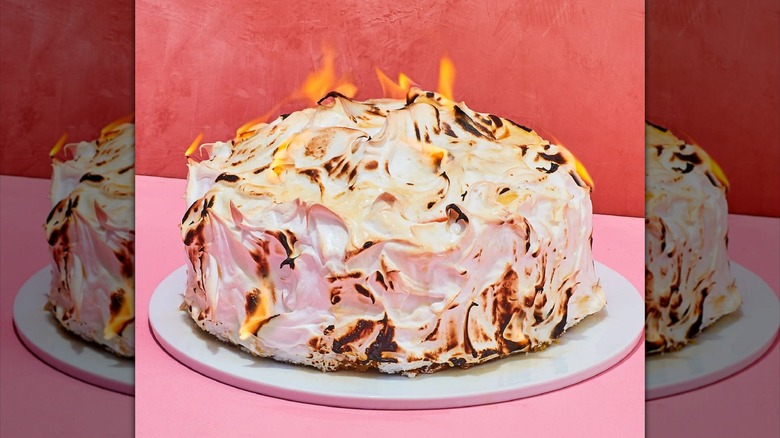 baked alaska set aflame with pink background