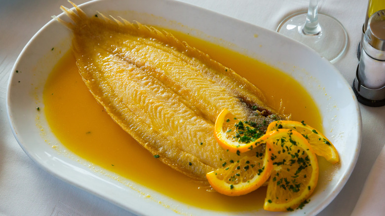 dover sole on plate with lemon and sauce