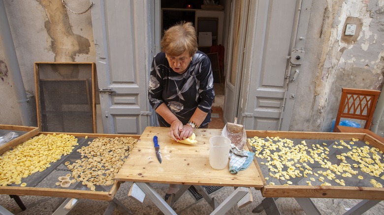 Woman making pasta outdoors