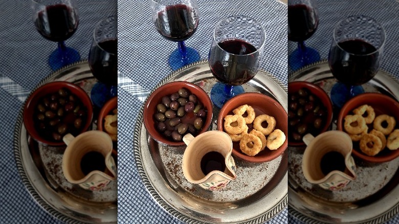 Primitivo wine, olives, tarallini crackers