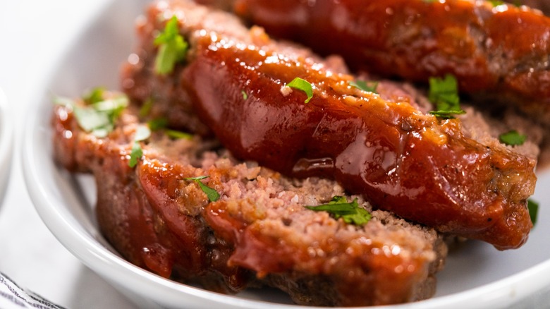 meatloaf sliced in white serving dish