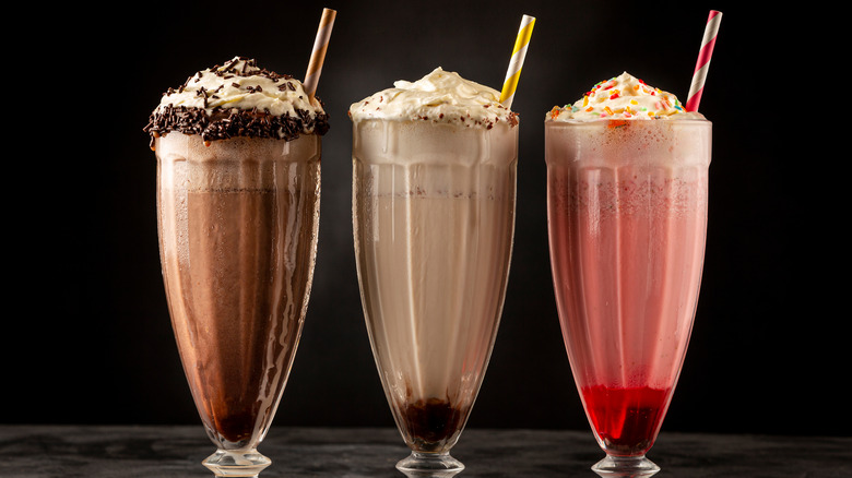 three milkshakes in glasses