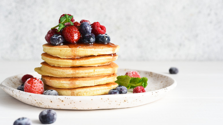 Pancakes berries on speckled plate