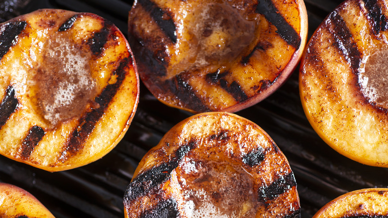 Close-up of grilled peach halves facing up