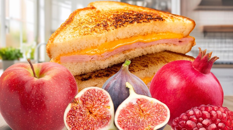 Grilled cheese cut in half with various fruits