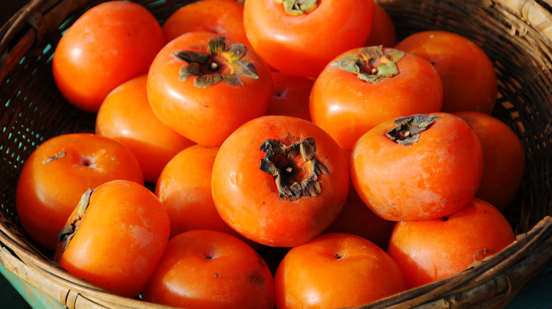 Ripe persimmons in a basket