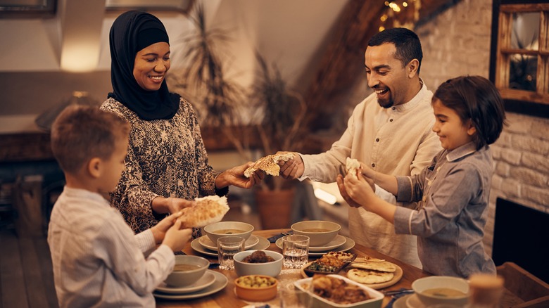 Muslim family enjoying dinner together