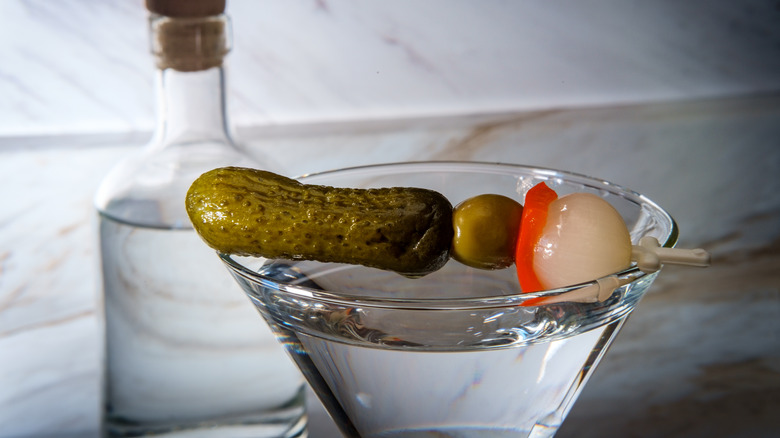 martini with pickle garnish