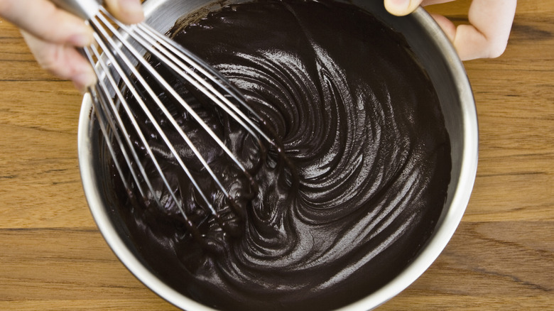 Whisking chocolate ganache in metal bowl