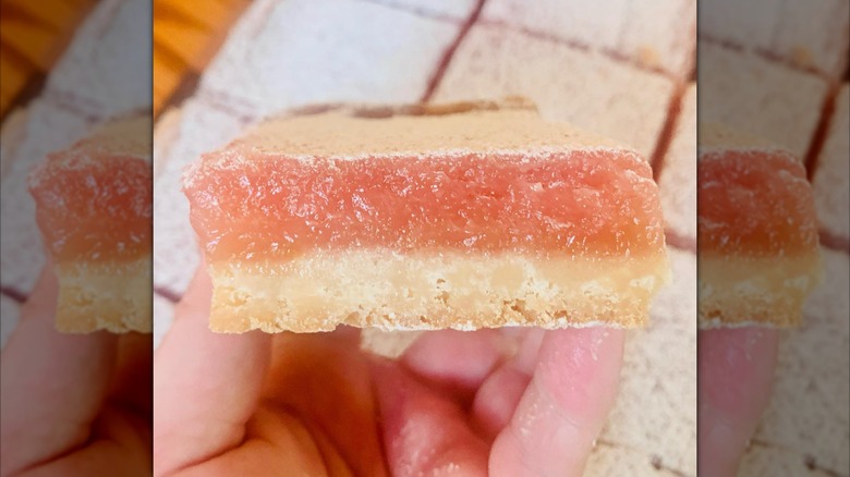 Hand holding pink lemon bar