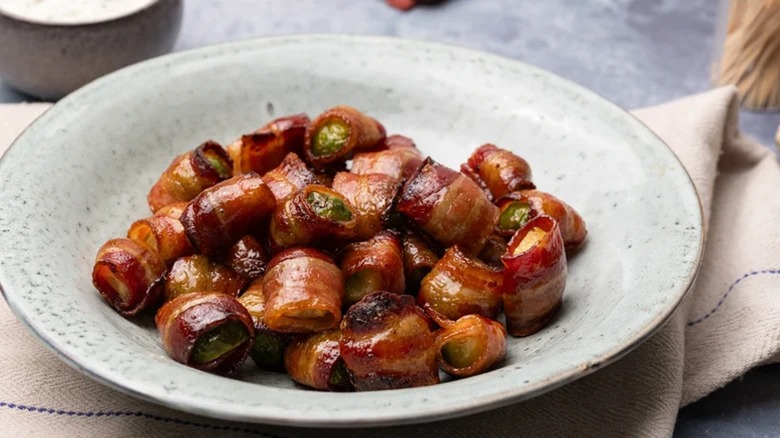 Bacon-Wrapped Balsamic Brussels Sprouts displayed in a serving dish