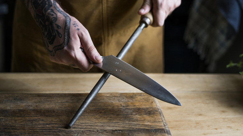 Person sharpening knife