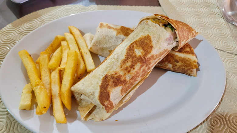 French fries and burrito on a plate