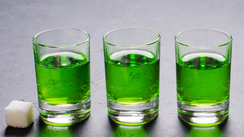 Three shot glasses of absinthe