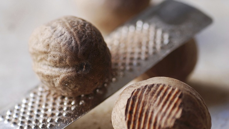 Grating whole nutmeg over microplane