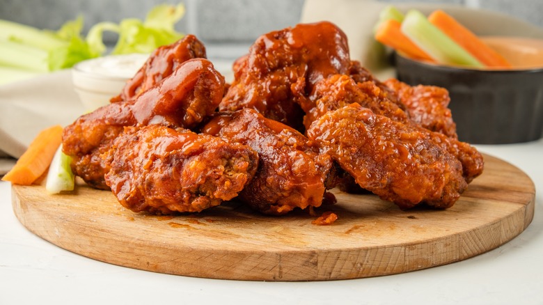 Buffalo wings on wooden board