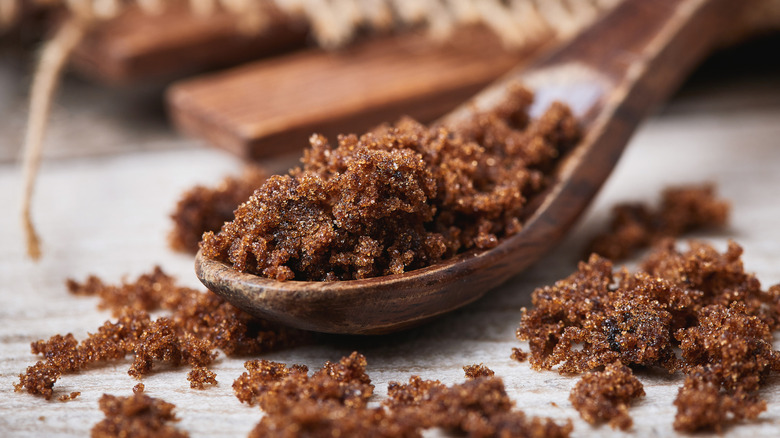 Granulated molasses on a wooden spoon