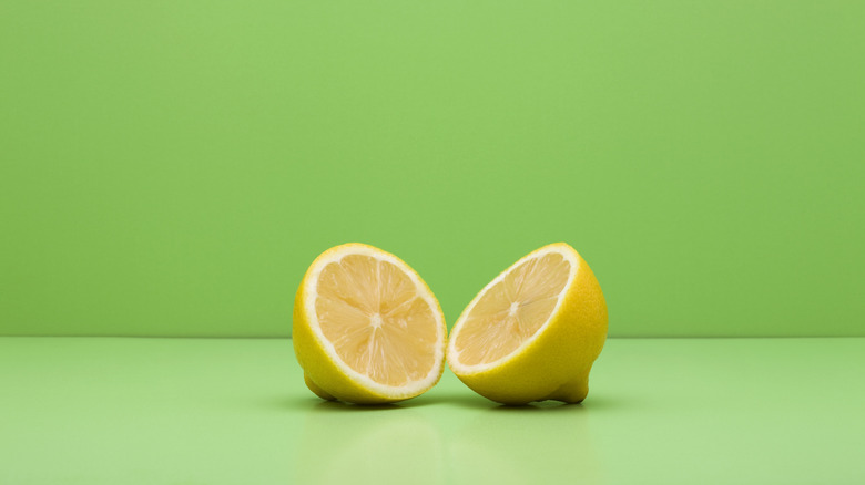 Sliced lemon with green background 