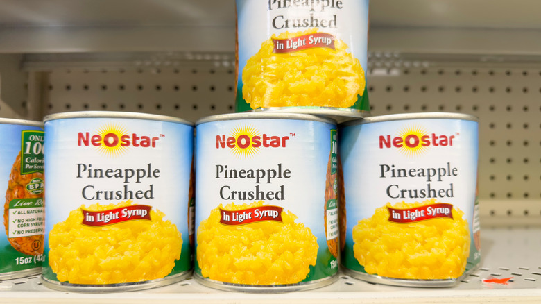 Cans of crushed pineapple on a shelf