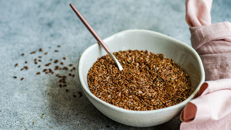 Bowl of whole flaxseeds with spoon