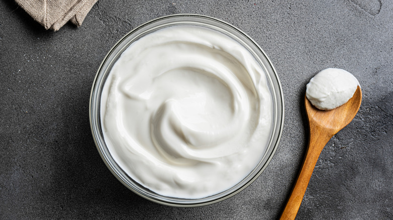 Bowl of greek yogurt with wooden spoon