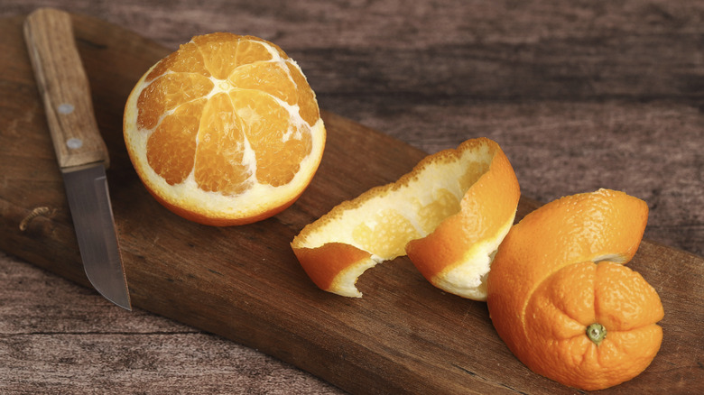 Partially peeled orange with skin