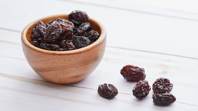 Wooden bowl of dried raisins