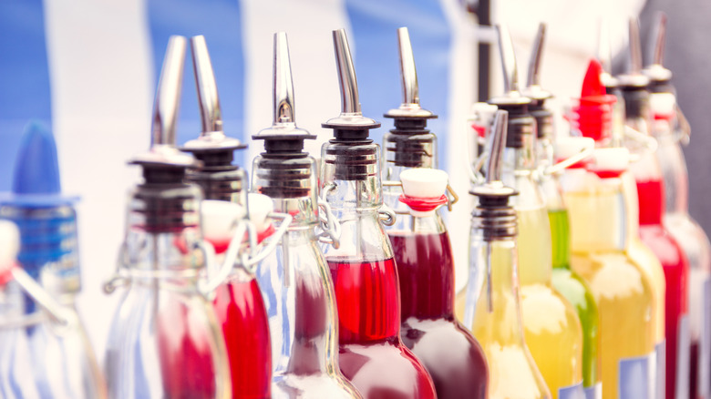 Colorful glass jars of different flavor syrups