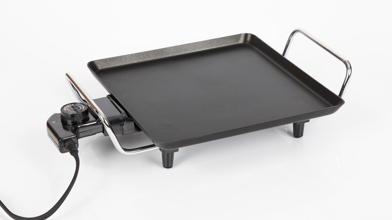 Electric griddle on white backdrop