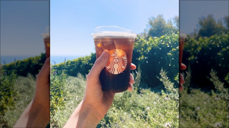 Hand holding Starbucks cold brew