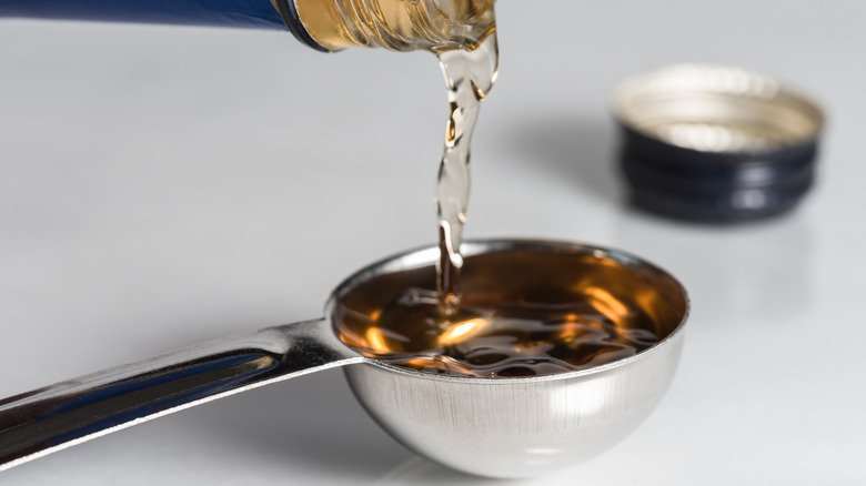 pouring sherry into measuring spoon