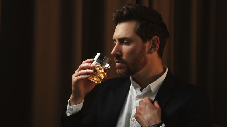 Man smelling whiskey