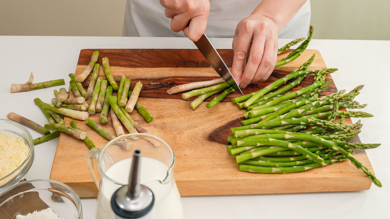 Trimming asparagus with knife