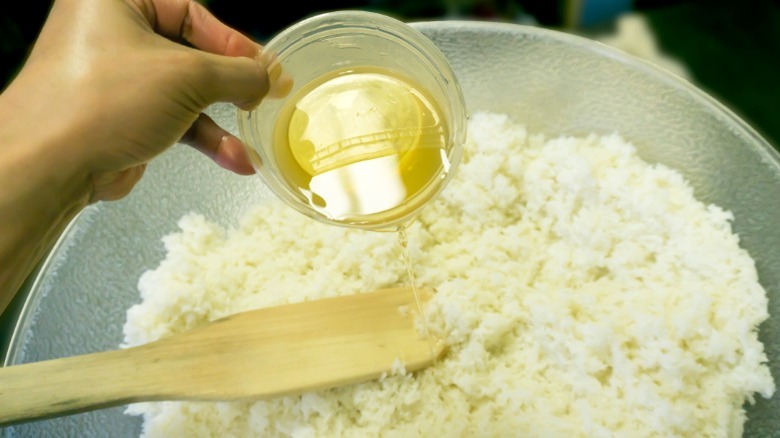 Rice vinegar being added to rice