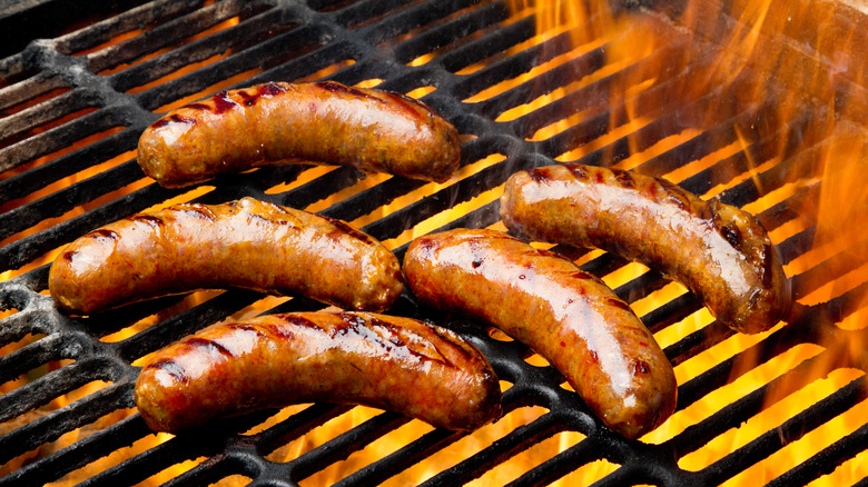 Grilling bratwurst on grill