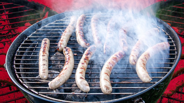 Bratwursts on grill with smoke