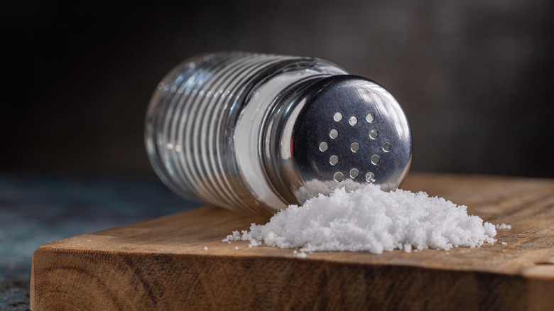 Salt shaker on wooden board