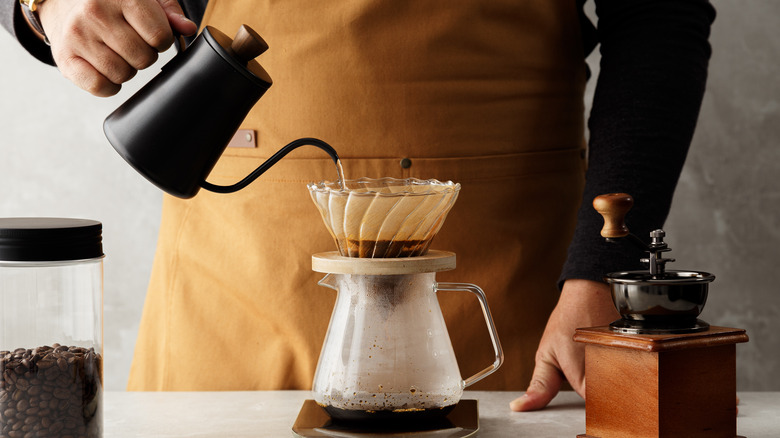 man making pour over coffee