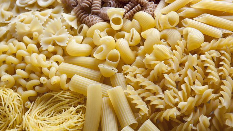 A table top view shows a variety of uncooked pasta.