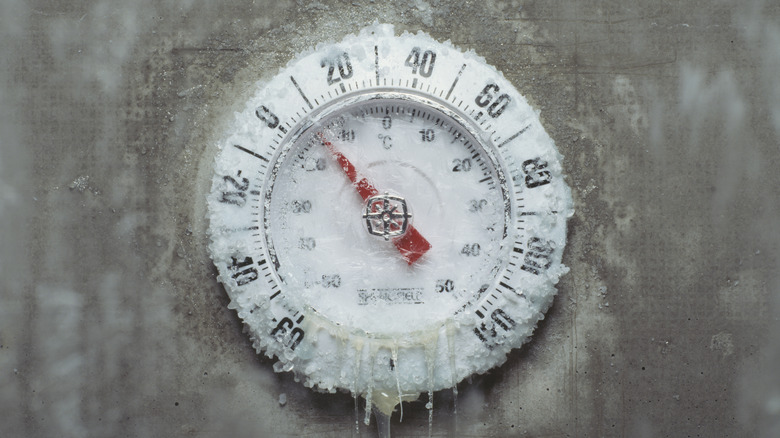 An icy thermometer shows a cold temperature.